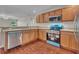 Bright kitchen featuring stainless steel appliances and wood cabinets at 1312 Catalina Blvd, Deltona, FL 32725