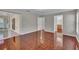 Open-concept living area with wood-look tile floors connecting to the patio, kitchen, and bath at 1312 Catalina Blvd, Deltona, FL 32725