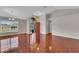 Open-concept living room with wood-look flooring, large window, and vaulted ceiling at 1312 Catalina Blvd, Deltona, FL 32725