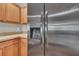 Stainless steel refrigerator with water and ice dispenser complements the wood cabinets at 1312 Catalina Blvd, Deltona, FL 32725