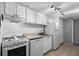 Well-lit kitchen featuring white appliances, cabinets, and granite countertops at 136 Blue Point Way # 320, Altamonte Springs, FL 32701