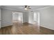 The open-concept living room has wood floors, neutral paint, and ample natural light at 136 Blue Point Way # 320, Altamonte Springs, FL 32701