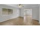 Bright living room with neutral walls, ceiling fan, wood-look flooring, and large window at 136 Blue Point Way # 320, Altamonte Springs, FL 32701