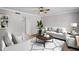 Living room with minimalist decor, wood-look floors, and a cozy seating arrangement at 136 Blue Point Way # 320, Altamonte Springs, FL 32701