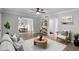 Living room features wood-look floors, light gray walls, and access to the dining area at 136 Blue Point Way # 320, Altamonte Springs, FL 32701