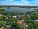 Scenic aerial shot of a lakefront community with luxurious homes and dense, mature trees at 1401 Green Cove Rd, Winter Park, FL 32789