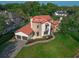 Stunning aerial view of the home with a lush lawn, tiled roof, and three-car garage and circular driveway at 1401 Green Cove Rd, Winter Park, FL 32789