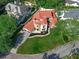 Lovely aerial view of a well-manicured lawn with circular driveway of a home with a tiled roof at 1401 Green Cove Rd, Winter Park, FL 32789