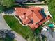Overhead view of a luxury home with a red tile roof, manicured lawn, and refreshing pool at 1401 Green Cove Rd, Winter Park, FL 32789