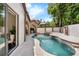 Inviting outdoor living space with a pool, spa, and an outdoor kitchen, perfect for entertaining guests at 1401 Green Cove Rd, Winter Park, FL 32789