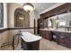 This stunning bathroom showcases a standalone tub, a shower, and beautiful custom cabinetry at 1401 Green Cove Rd, Winter Park, FL 32789