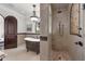Elegant bathroom featuring a standalone tub, walk-in shower, and ornate lighting fixtures at 1401 Green Cove Rd, Winter Park, FL 32789