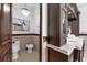 This half bathroom features custom wood cabinetry and intricate tile work at 1401 Green Cove Rd, Winter Park, FL 32789