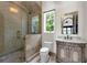 Bathroom featuring a walk-in shower, vanity, and window with natural light at 1401 Green Cove Rd, Winter Park, FL 32789