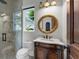 Traditional-style bathroom with a vanity, shower, toilet, and window at 1401 Green Cove Rd, Winter Park, FL 32789