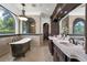 Luxurious bathroom with a soaking tub, dual vanities, and detailed tile work, creating a spa-like retreat at 1401 Green Cove Rd, Winter Park, FL 32789