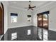 Spacious bedroom with black marble floors, large windows, and access to a balcony at 1401 Green Cove Rd, Winter Park, FL 32789