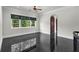 Large bedroom with dark marble flooring, a ceiling fan, and window with bright natural light at 1401 Green Cove Rd, Winter Park, FL 32789