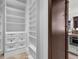 Custom closet with white cabinets, drawers, shelving, and travertine flooring at 1401 Green Cove Rd, Winter Park, FL 32789