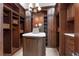 Custom walk-in closet with dark wood cabinetry, marble countertop, and ample storage space at 1401 Green Cove Rd, Winter Park, FL 32789