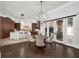 Dining area with wood floors, modern chandelier, and connection to the kitchen area at 1401 Green Cove Rd, Winter Park, FL 32789