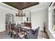 Elegant dining room with decorative chandelier, detailed ceiling and stone flooring at 1401 Green Cove Rd, Winter Park, FL 32789