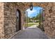 The stone archway provides a unique entrance to the house with iron gates at 1401 Green Cove Rd, Winter Park, FL 32789