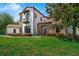 Lovely home features a stone archway, balcony, and professionally landscaped front yard at 1401 Green Cove Rd, Winter Park, FL 32789
