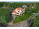 Elegant two-story home with a well-manicured lawn, a circular driveway, and a two car garage at 1401 Green Cove Rd, Winter Park, FL 32789