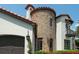 The home features a stone turret, terracotta roof and an attached two car garage at 1401 Green Cove Rd, Winter Park, FL 32789