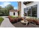 Exquisite landscaping frames a view of the stone turret, terracotta roof and fountain at 1401 Green Cove Rd, Winter Park, FL 32789