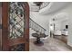 Grand foyer featuring a sweeping staircase, wrought iron details, and elegant decor at 1401 Green Cove Rd, Winter Park, FL 32789