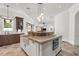 Large kitchen island with a sink and oven offering a view into the living space at 1401 Green Cove Rd, Winter Park, FL 32789