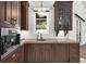 Well-appointed kitchen with dark wood cabinetry, stone countertops, stainless steel appliance and a view of the backyard at 1401 Green Cove Rd, Winter Park, FL 32789
