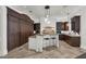 Elegant kitchen with dark wood cabinets, a central island, and stone countertops at 1401 Green Cove Rd, Winter Park, FL 32789