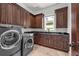 Laundry room with washer, dryer, custom cabinets, and sink at 1401 Green Cove Rd, Winter Park, FL 32789