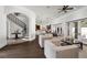 Bright, open living room with arched doorways, staircase, wood floors, and French doors at 1401 Green Cove Rd, Winter Park, FL 32789