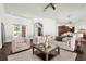 Cozy living room with plush sofas, glass coffee table, and arched doorway leading to the foyer at 1401 Green Cove Rd, Winter Park, FL 32789