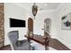 A view of the office with decorative lighting, stone wall, and hardwood floors at 1401 Green Cove Rd, Winter Park, FL 32789
