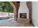 Relaxing outdoor fireplace with stone surround near the pool and outdoor living space at 1401 Green Cove Rd, Winter Park, FL 32789