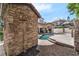 Charming backyard with stone outdoor shower, swimming pool, and lounge area perfect for relaxation at 1401 Green Cove Rd, Winter Park, FL 32789