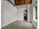 Bedroom with hardwood flooring, exposed wood ceiling beams, and arched doorways at 1401 Green Cove Rd, Winter Park, FL 32789