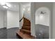 Staircase with dark marble floors and an archway leading into another room at 1401 Green Cove Rd, Winter Park, FL 32789
