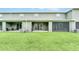 Lush green backyard with covered patio space including both an open patio and a screened-in patio, plus AC units at 1401 Yellow Finch Dr, Davenport, FL 33837