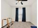 Comfortable bedroom features a ceiling fan, plush carpet, window and exercise equipment at 1401 Yellow Finch Dr, Davenport, FL 33837