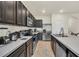 Kitchen with dark wood cabinets, stainless steel appliances, and ample countertop space at 1401 Yellow Finch Dr, Davenport, FL 33837
