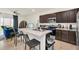 Kitchen featuring an island with barstool seating, dark wood cabinetry, and stainless steel appliances at 1401 Yellow Finch Dr, Davenport, FL 33837