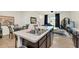 Kitchen with an island, stainless steel appliances, and an adjacent living area at 1401 Yellow Finch Dr, Davenport, FL 33837