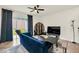Inviting living room with a ceiling fan, a blue sofa and sliding glass doors to backyard at 1401 Yellow Finch Dr, Davenport, FL 33837