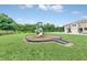 Neighborhood playground with slide and surrounding green grass and nearby townhomes offers fun for children at 1401 Yellow Finch Dr, Davenport, FL 33837
